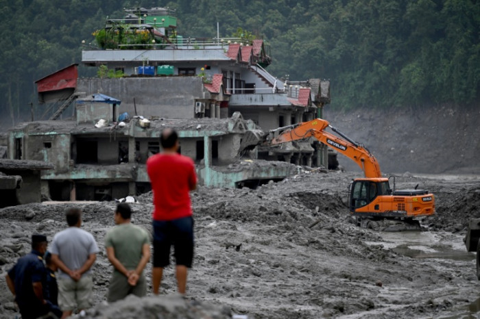 Nepal recovers bodies but presses on for trapped tunnel workers